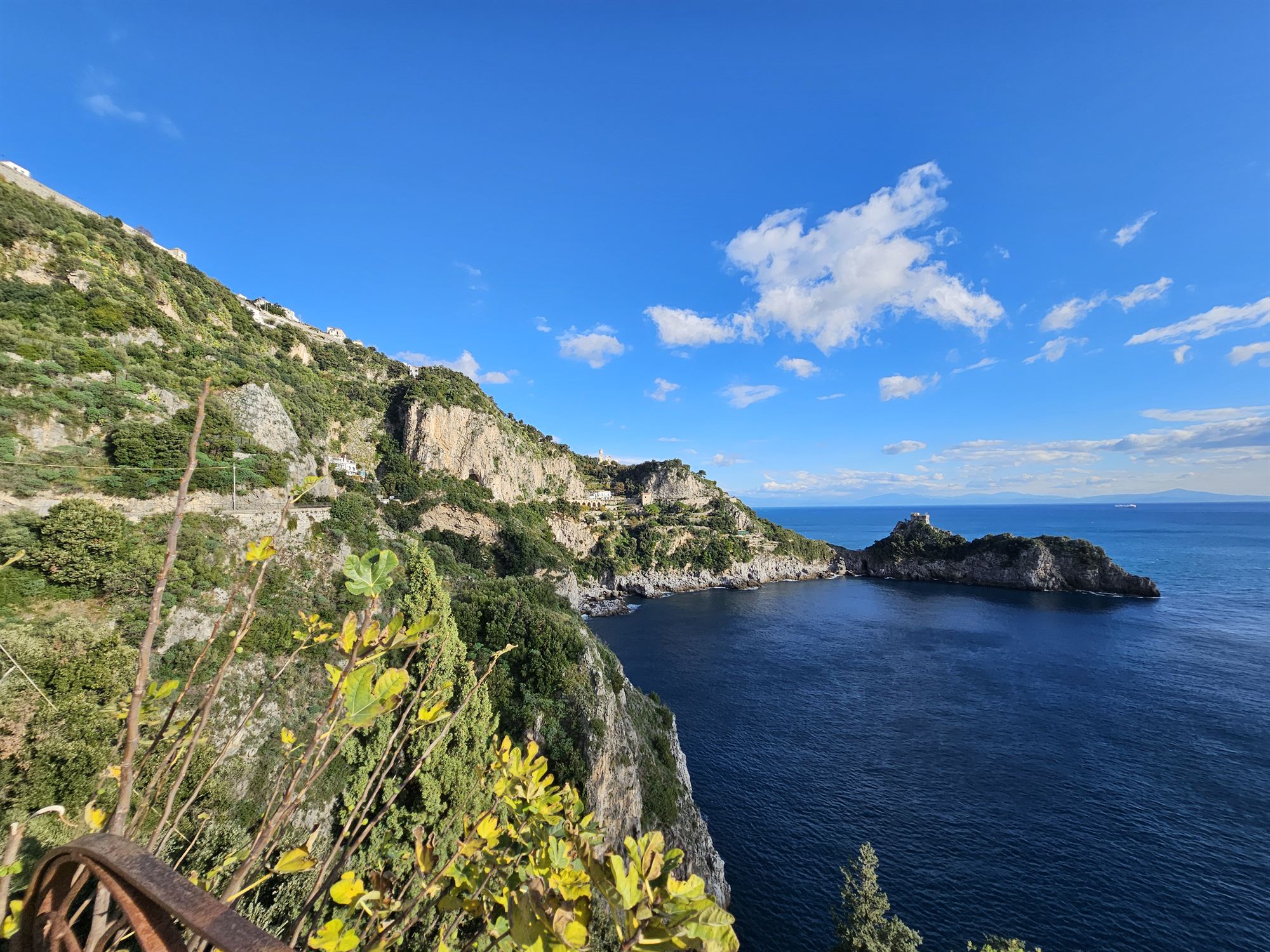 A viewpoint along the Amalfi coastal road, cliffs and sea stretching ahead