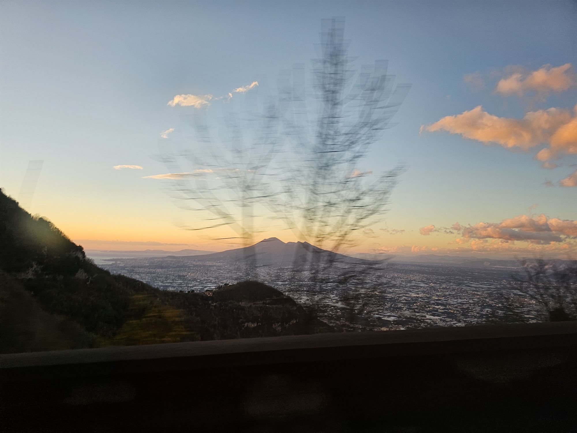 Mount Vesuvius silhouetted at sunset, seen from the road back to Naples