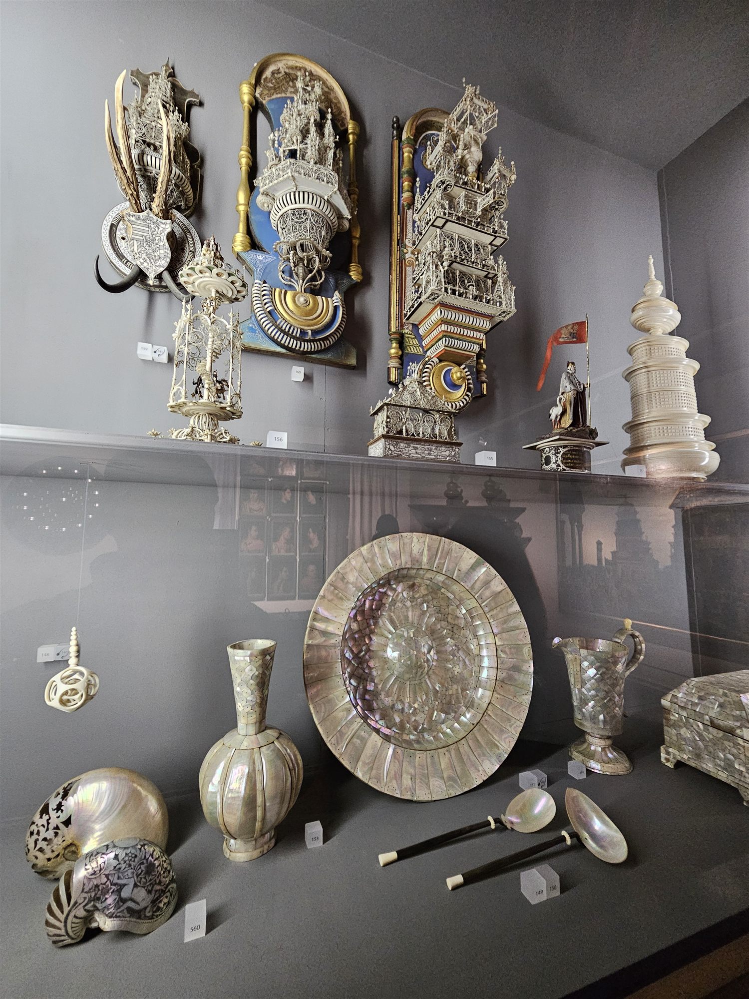 Display cabinet of intricately carved ivory and mother-of-pearl objects in the Kunstkammer at Ambras Castle