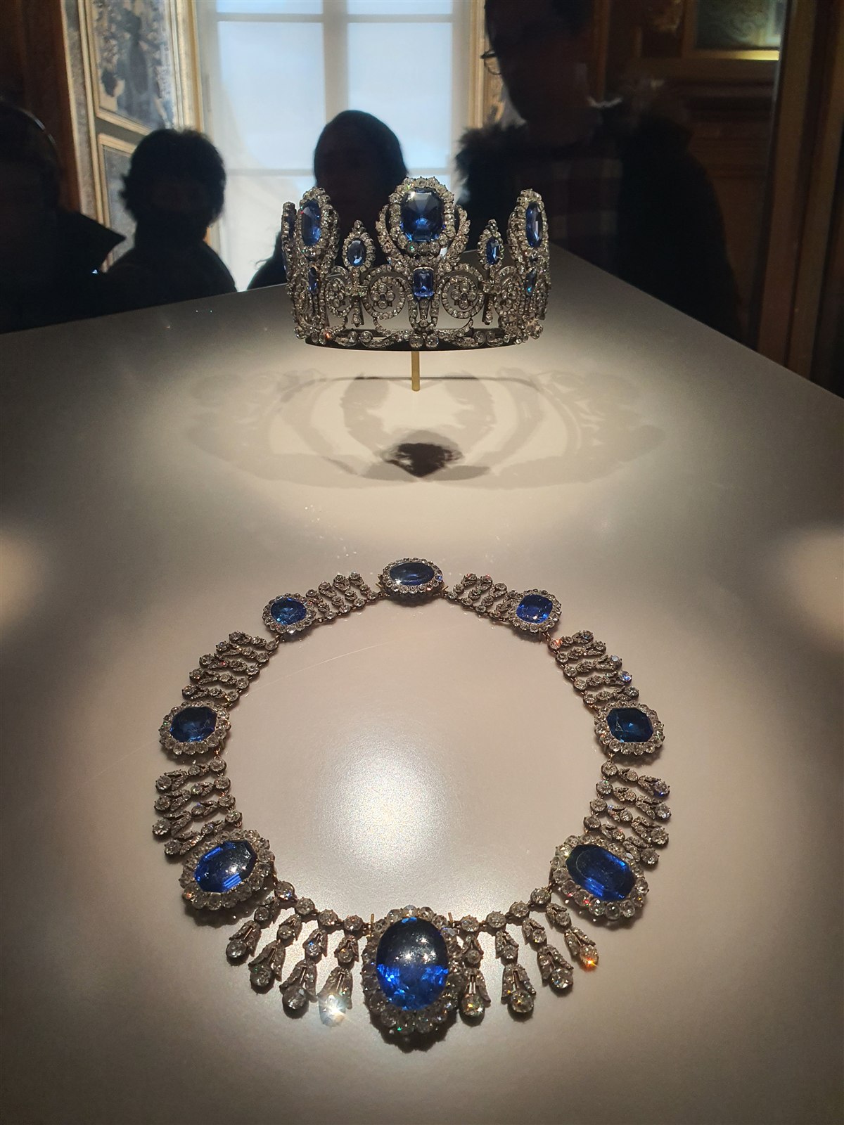 A sapphire and diamond necklace and a sapphire crown on display at the Louvre