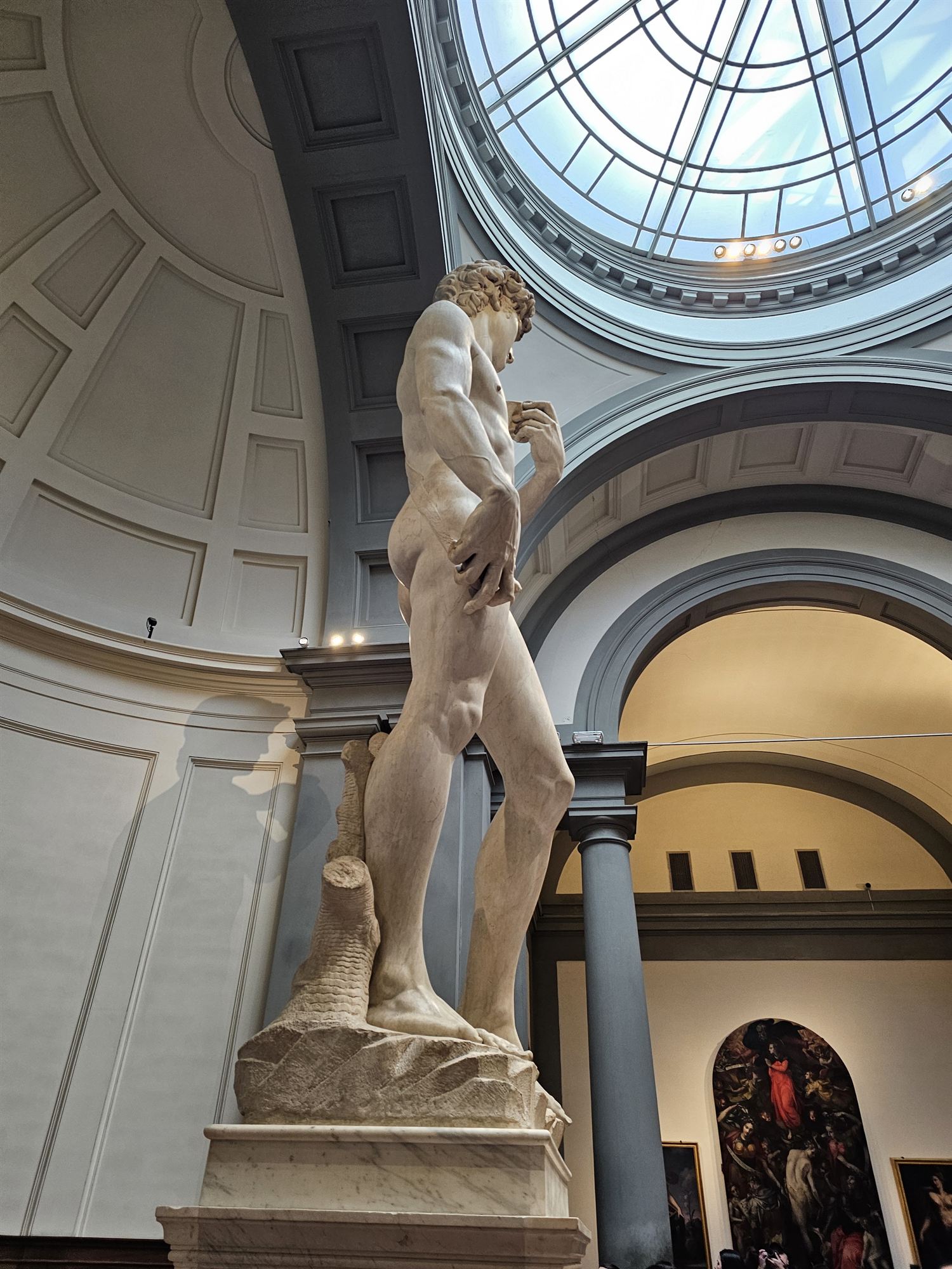 A close-up view of Michelangelo's David, looking up at the statue's detail