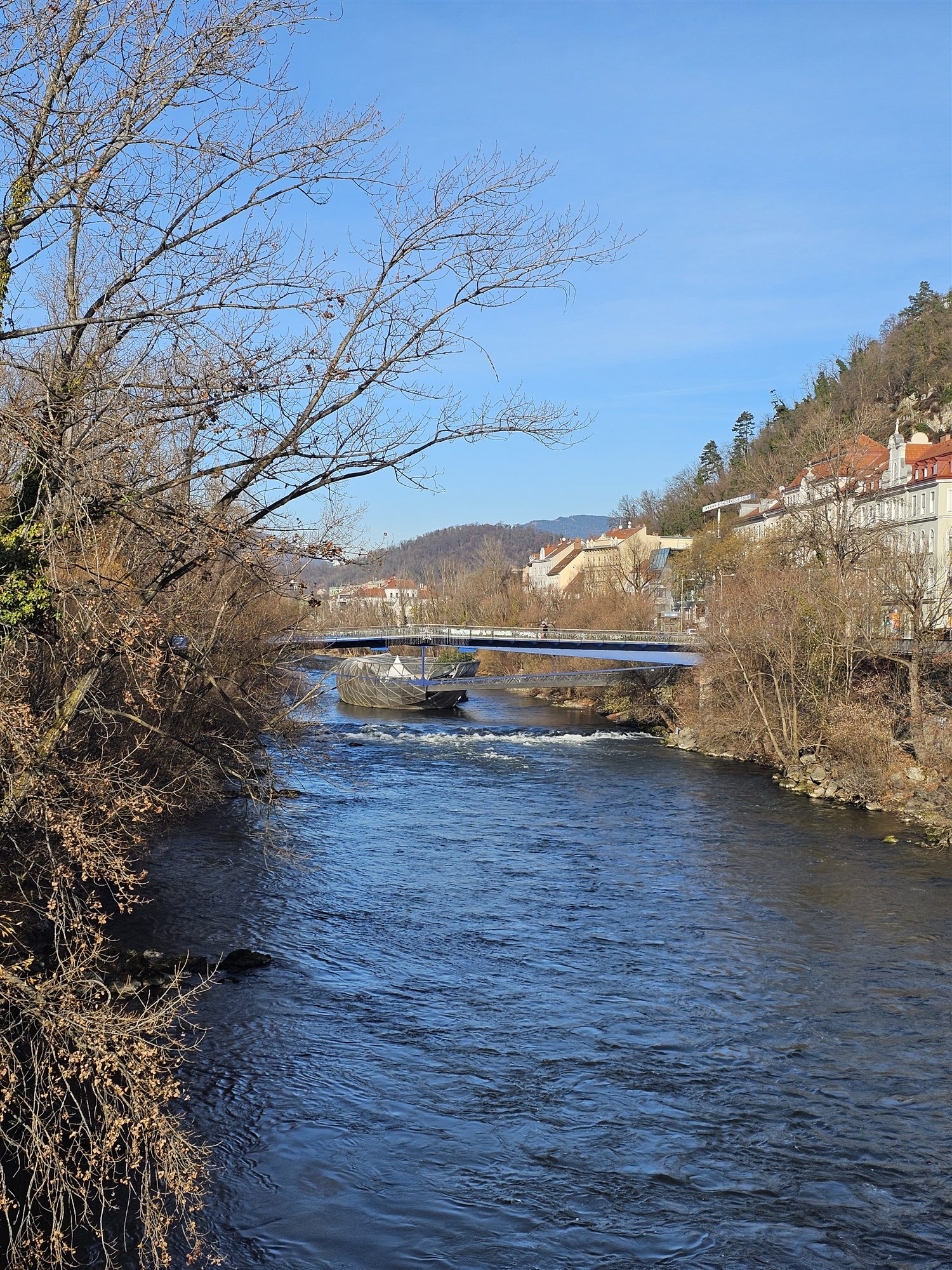 The Murinsel floating platform seen from the riverbank, Graz