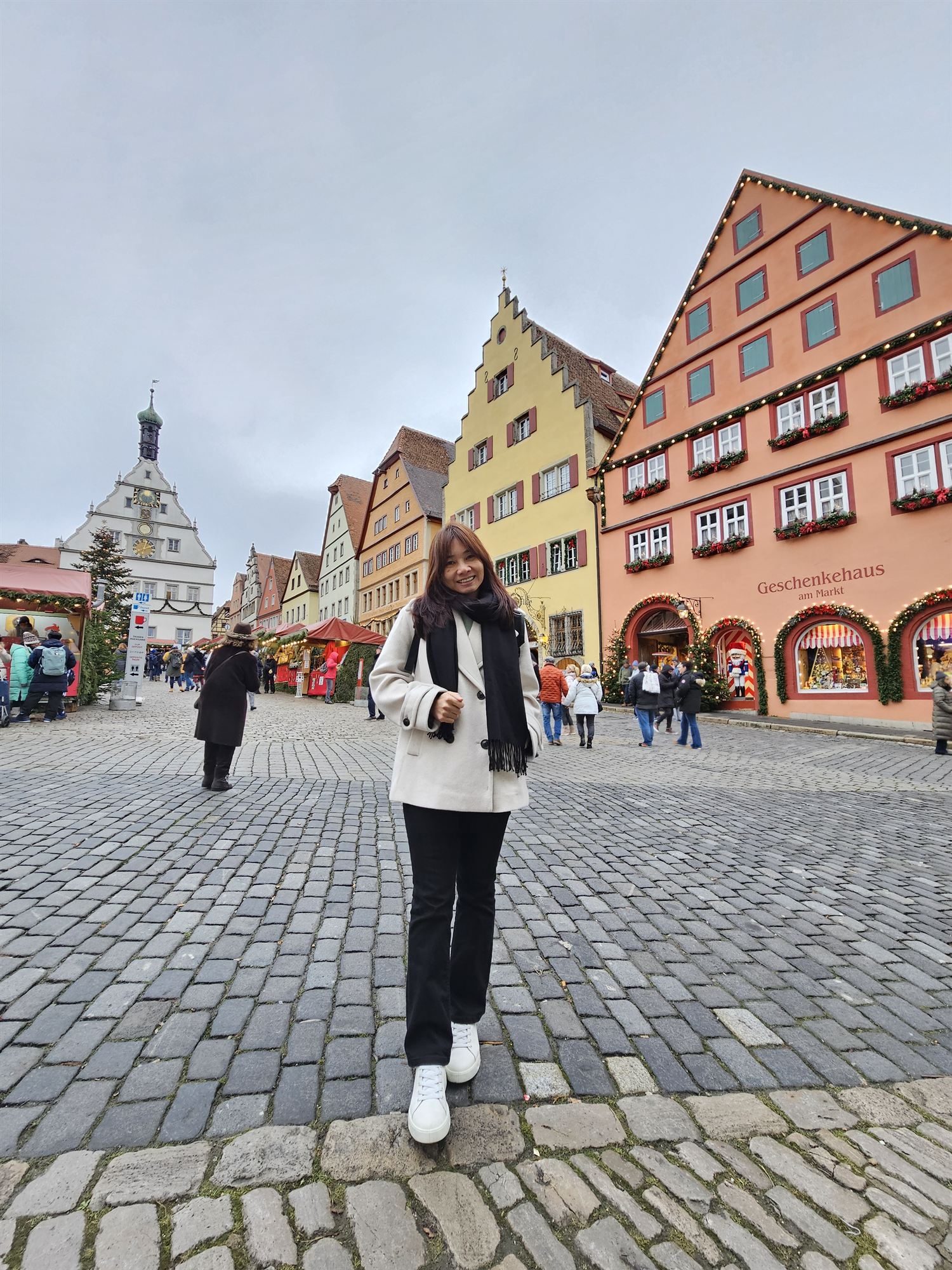 Standing in Rothenburg's market square, colourful gabled houses and the Geschenkehaus am Markt shop