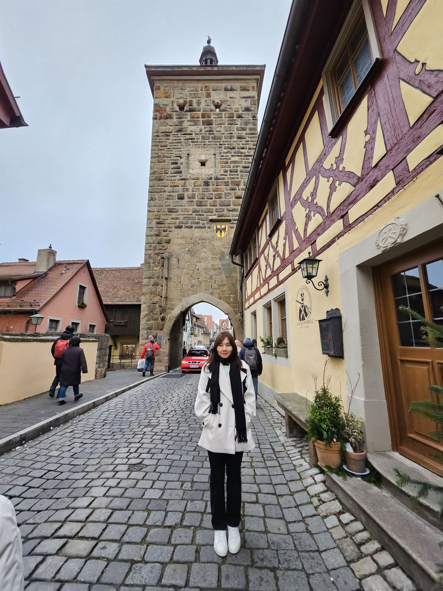 Standing before the Siebersturm gate tower in Rothenburg ob der Tauber