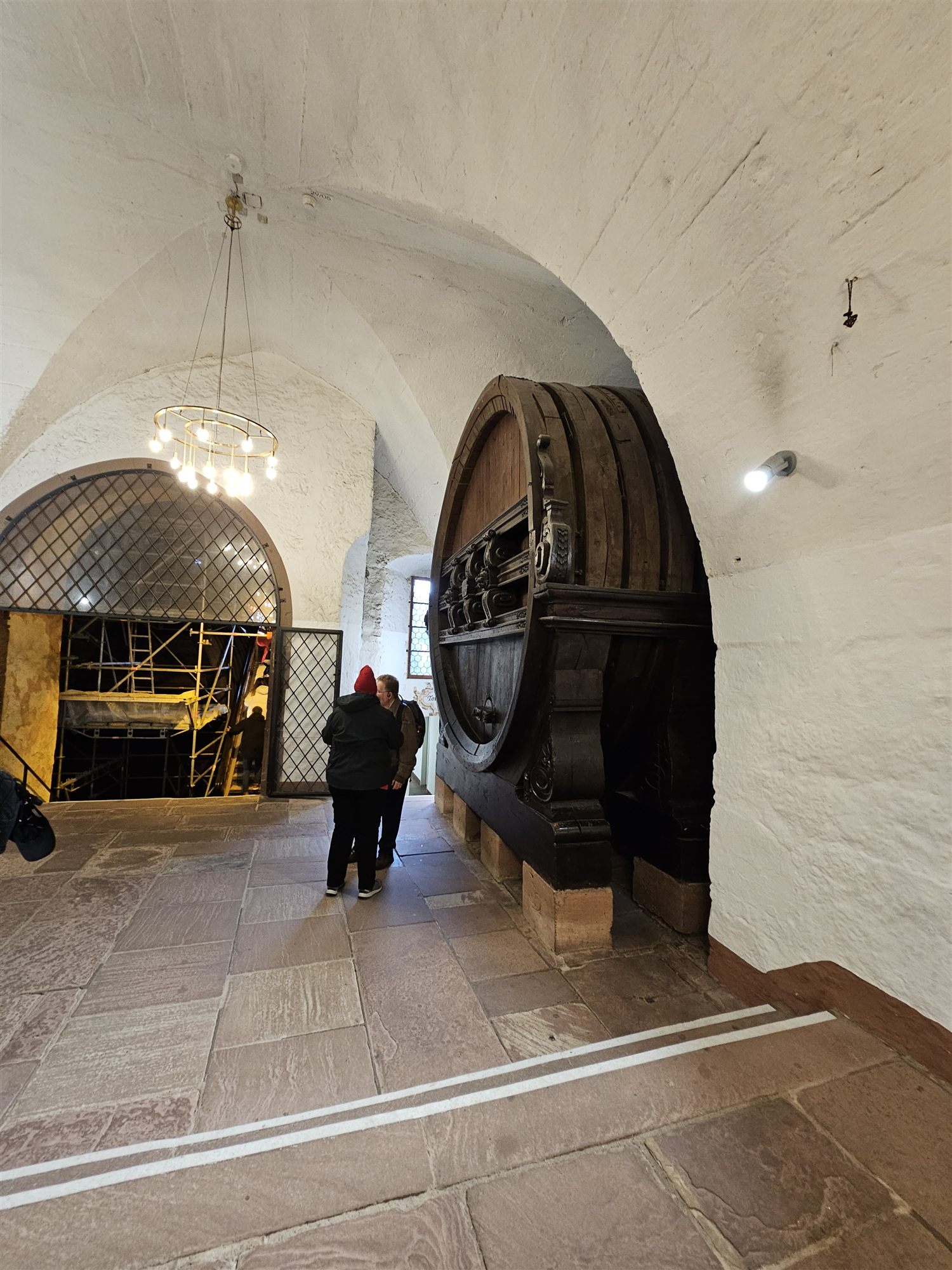 The Great Heidelberg Tun seen through a stone archway in the castle cellar