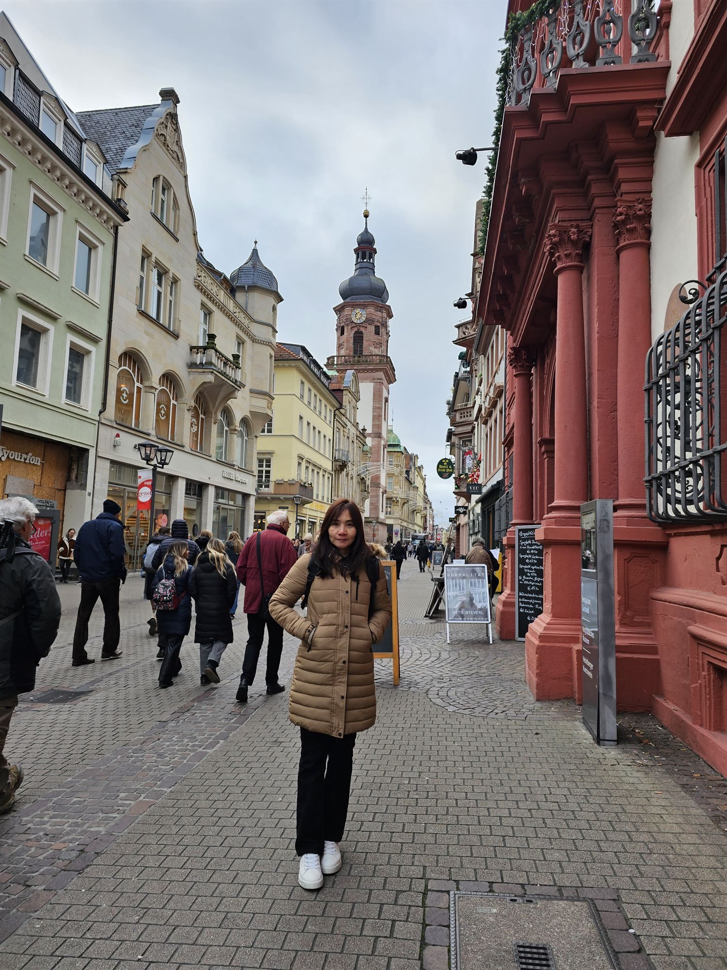 Walking down Hauptstraße toward the Heiliggeistkirche tower in Heidelberg's old town