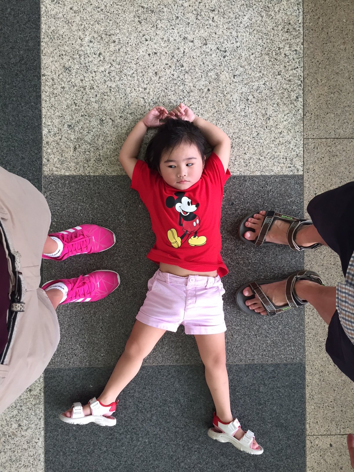 Our daughter sprawled out on the palace floor between our feet, mid-explore