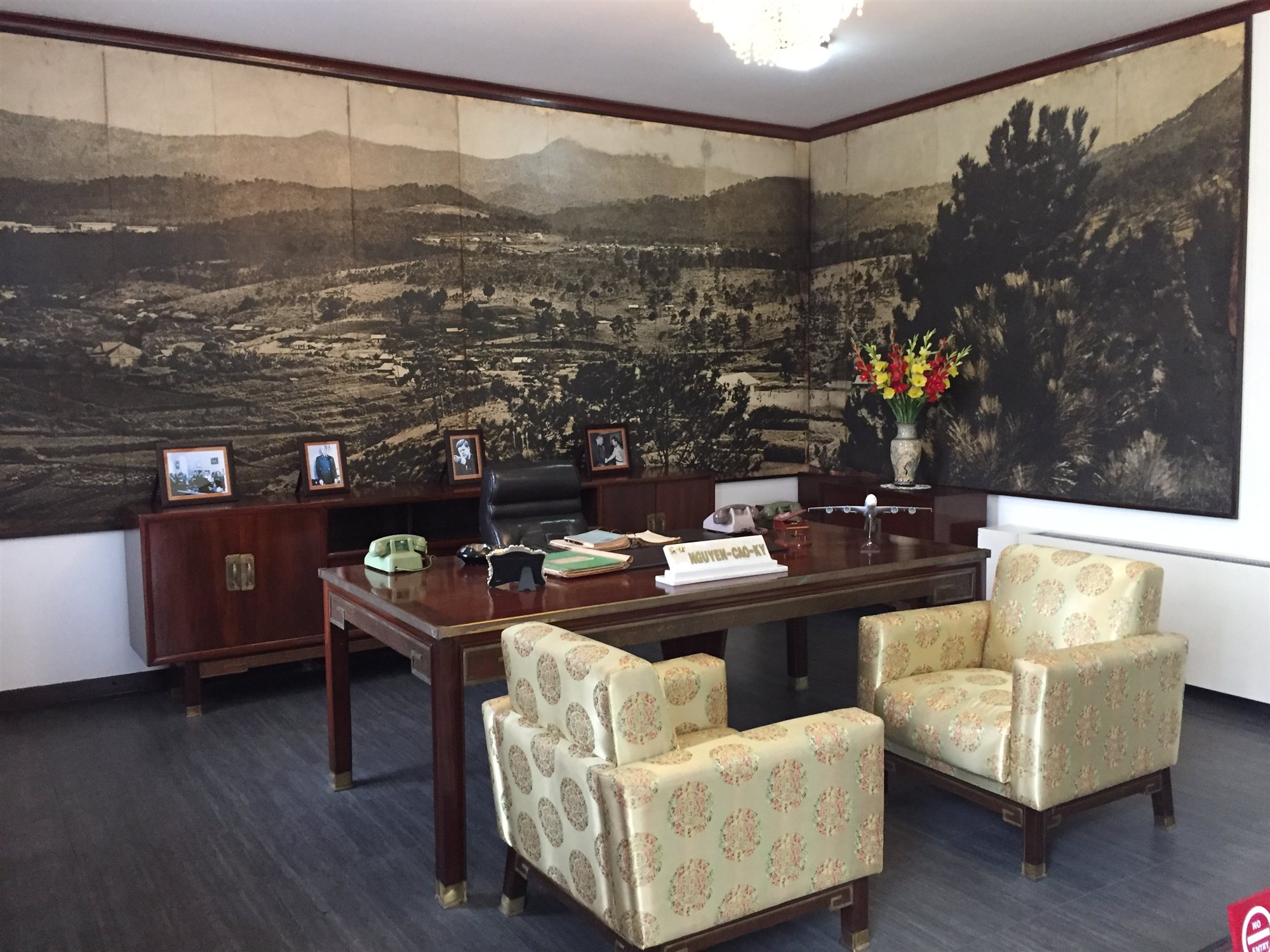 A preserved office inside the Independence Palace, with original furniture and portraits