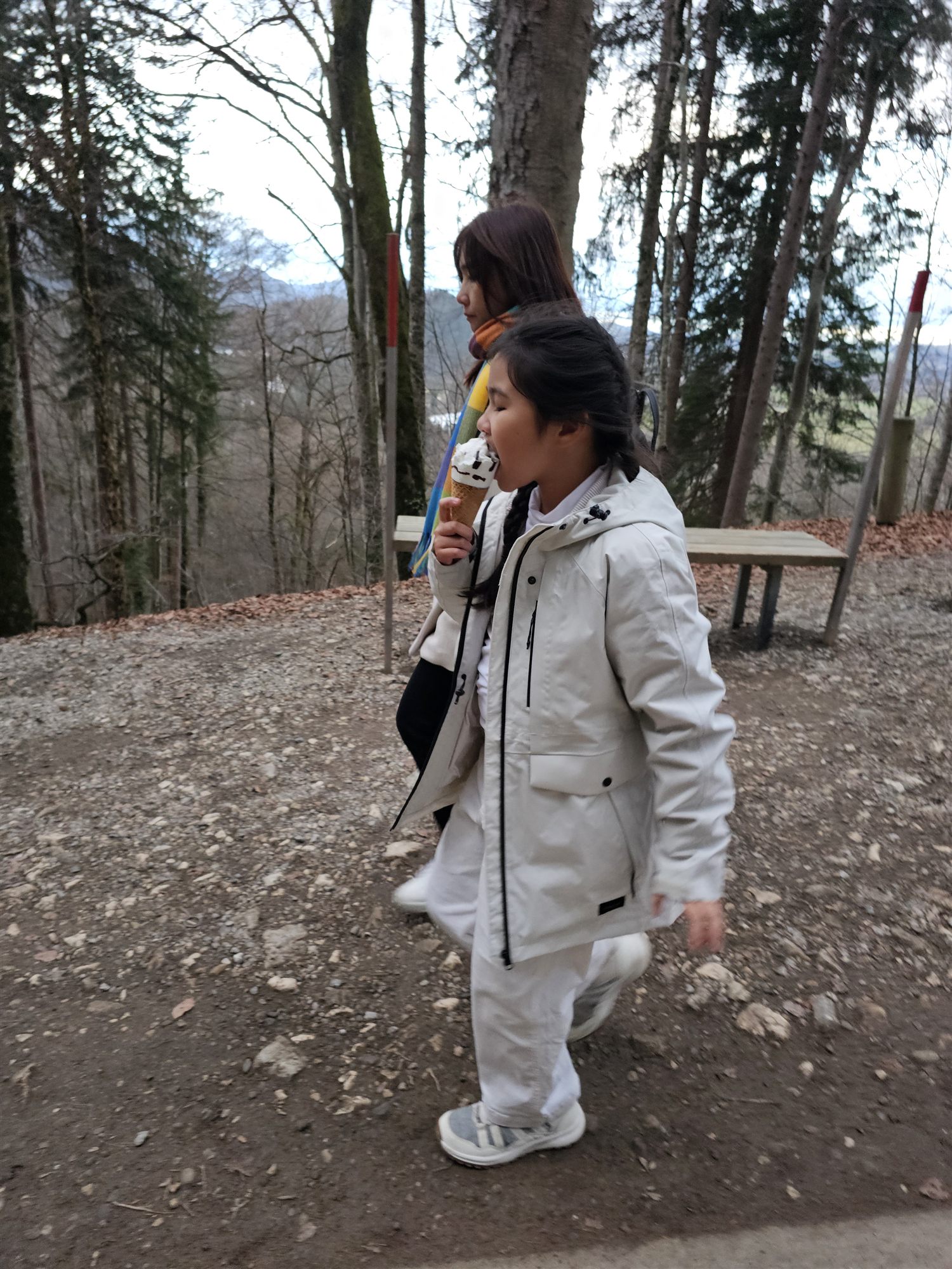 Our daughter eating an ice cream cone on the forest path down from Neuschwanstein