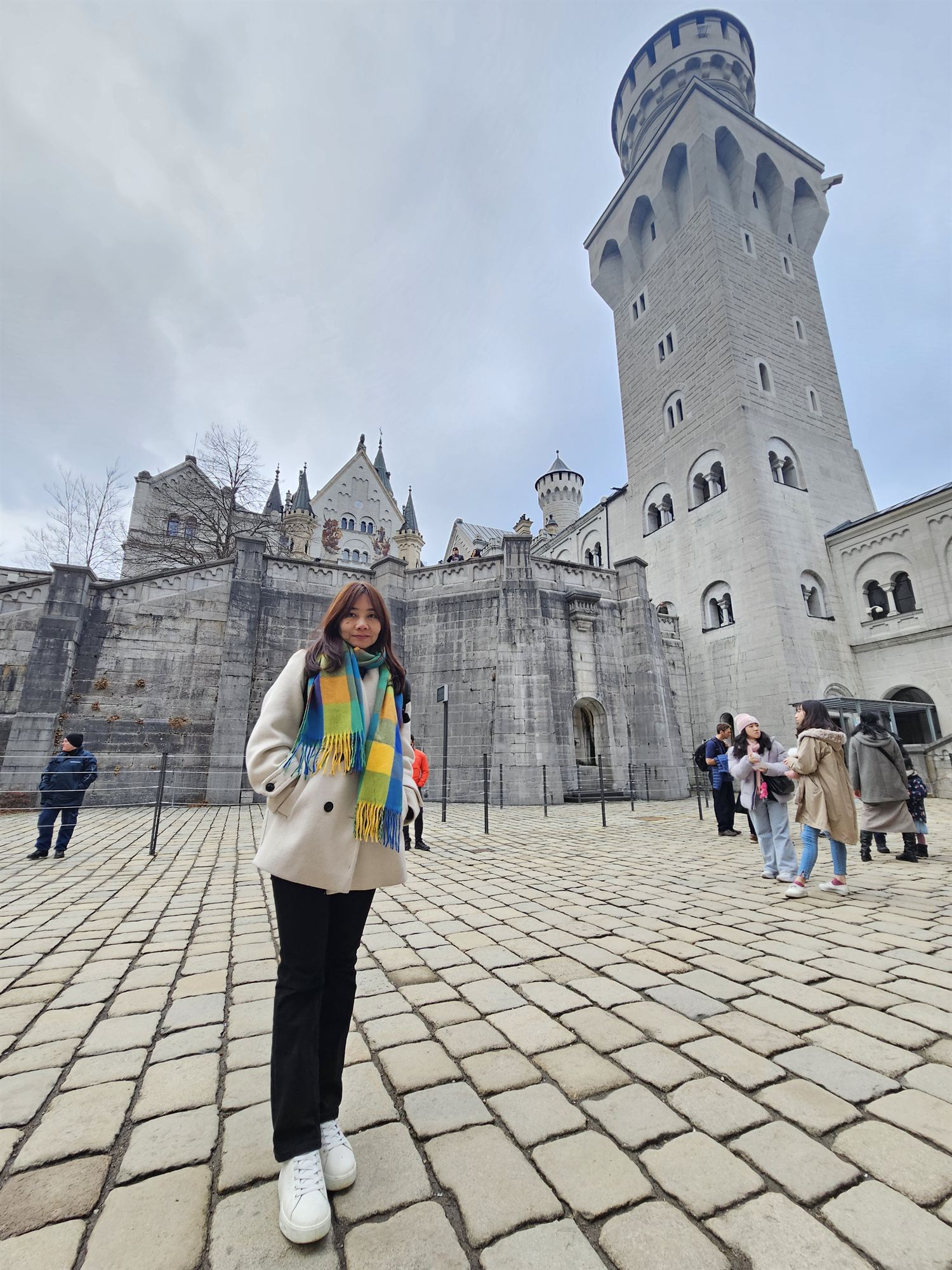 Standing before one of Neuschwanstein Castle's towers