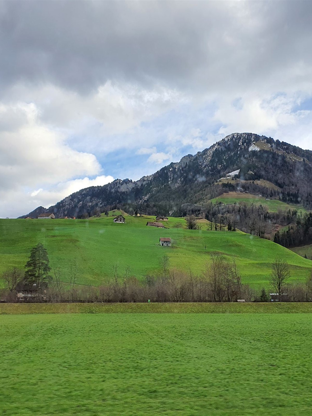 Snow-capped mountains above a green valley near Engelberg, Switzerland