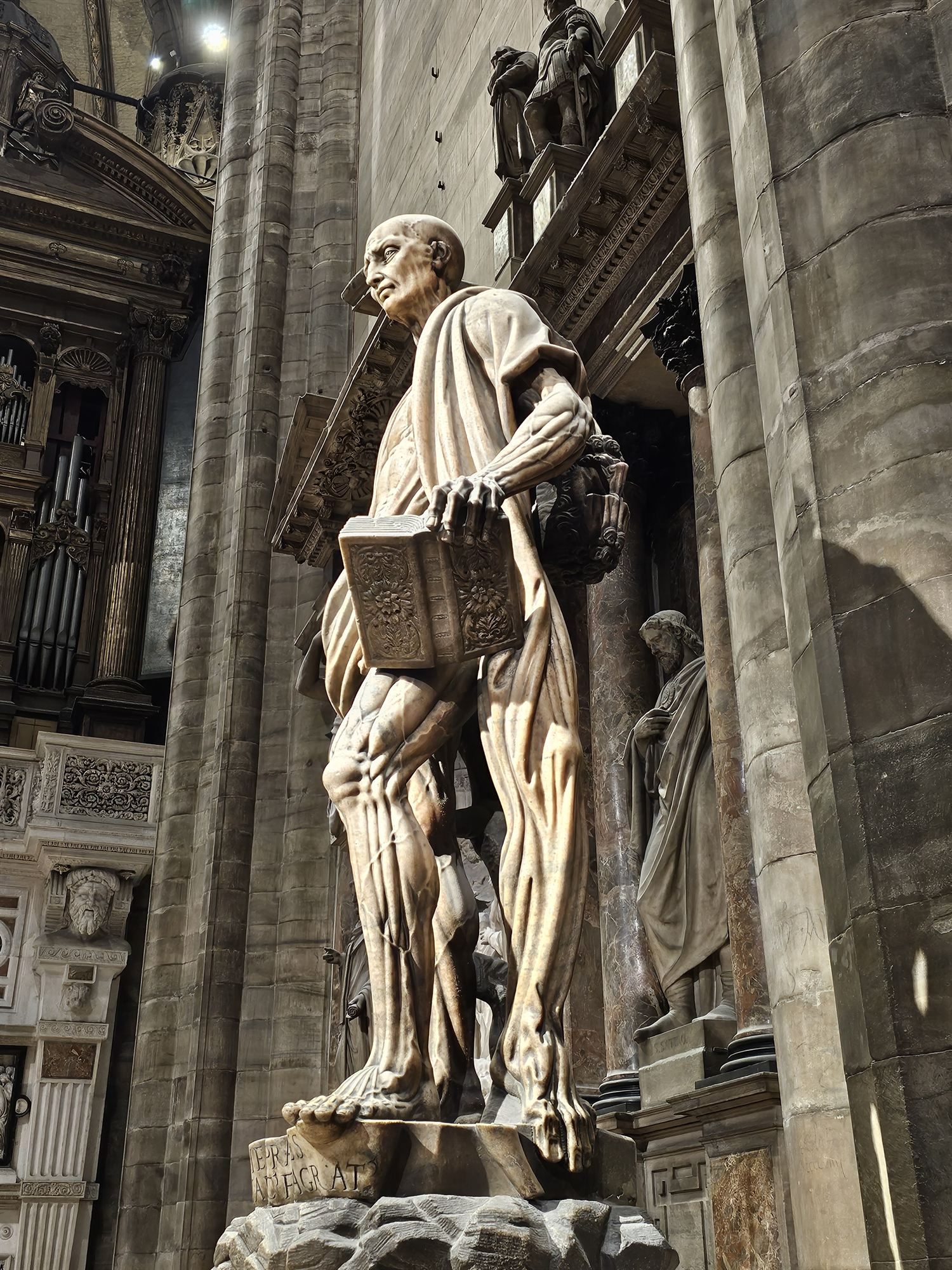 The statue of St Bartholomew inside the Duomo di Milano, carrying his own flayed skin