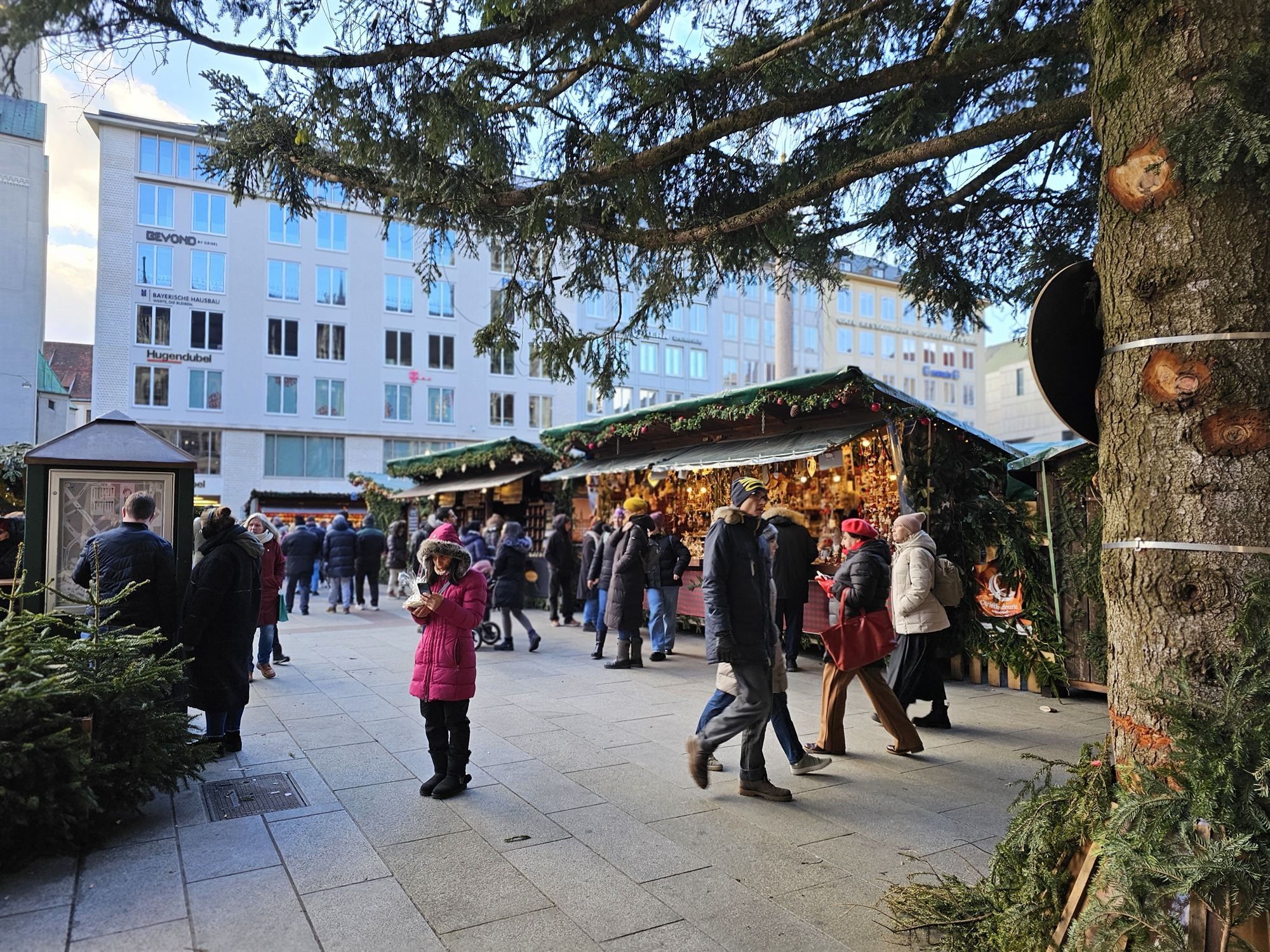 A Christmas market stall beneath a decorated tree in Munich's old town