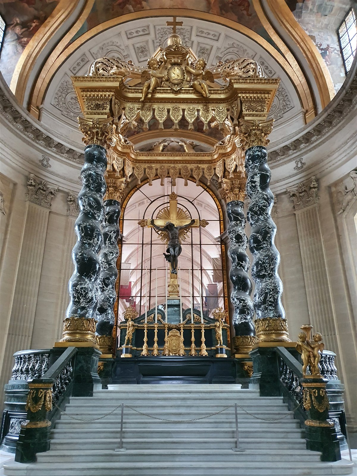 The gilded altar and canopy inside the Dôme des Invalides, with its black marble columns