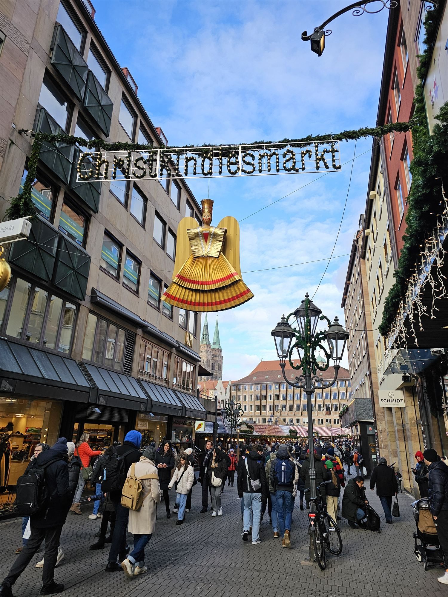 The Christkindlesmarkt entrance sign, a golden angel figure hanging above the street
