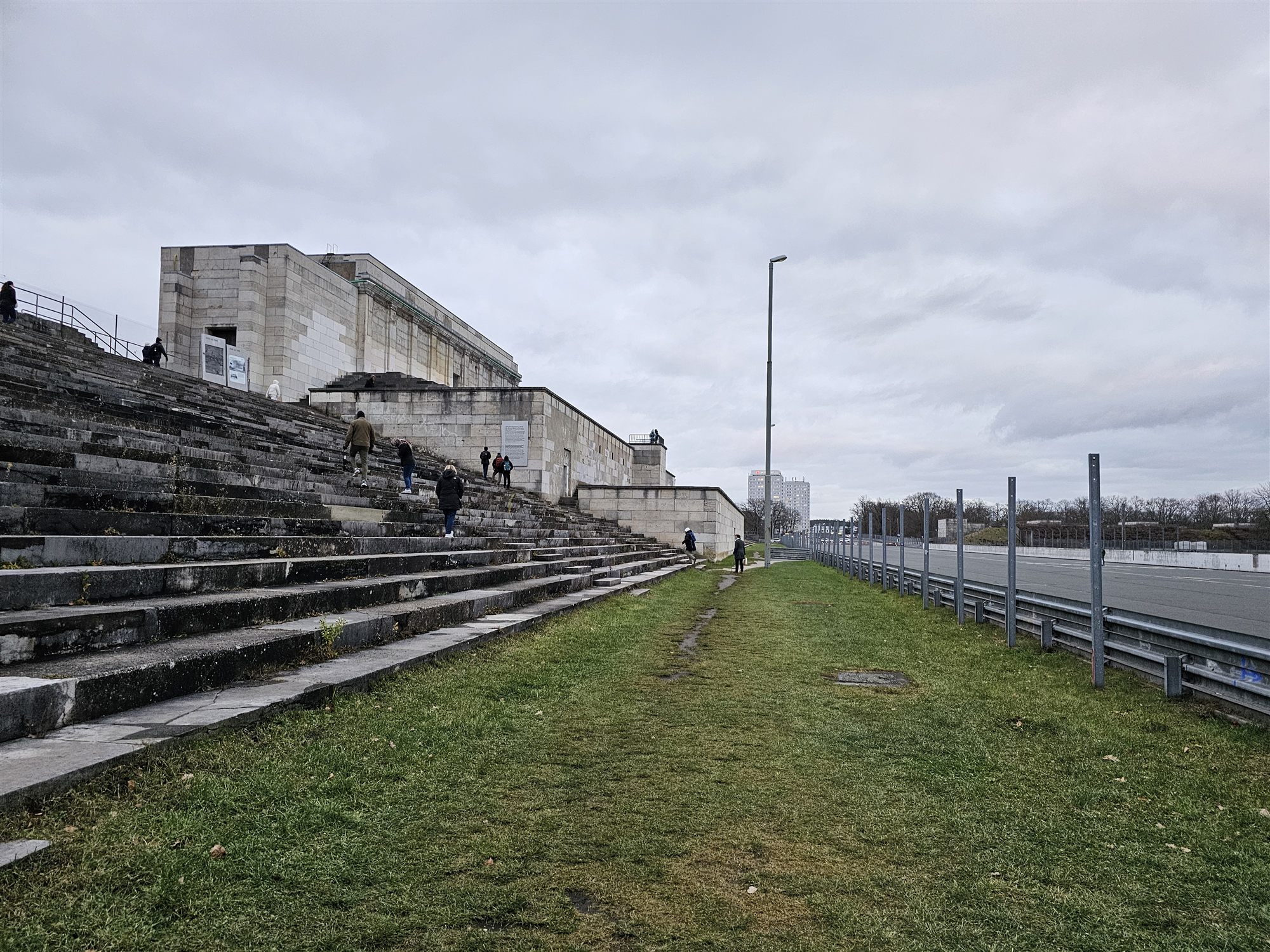 The empty stone steps of the Zeppelinfeld grandstand in Nuremberg, under a grey sky