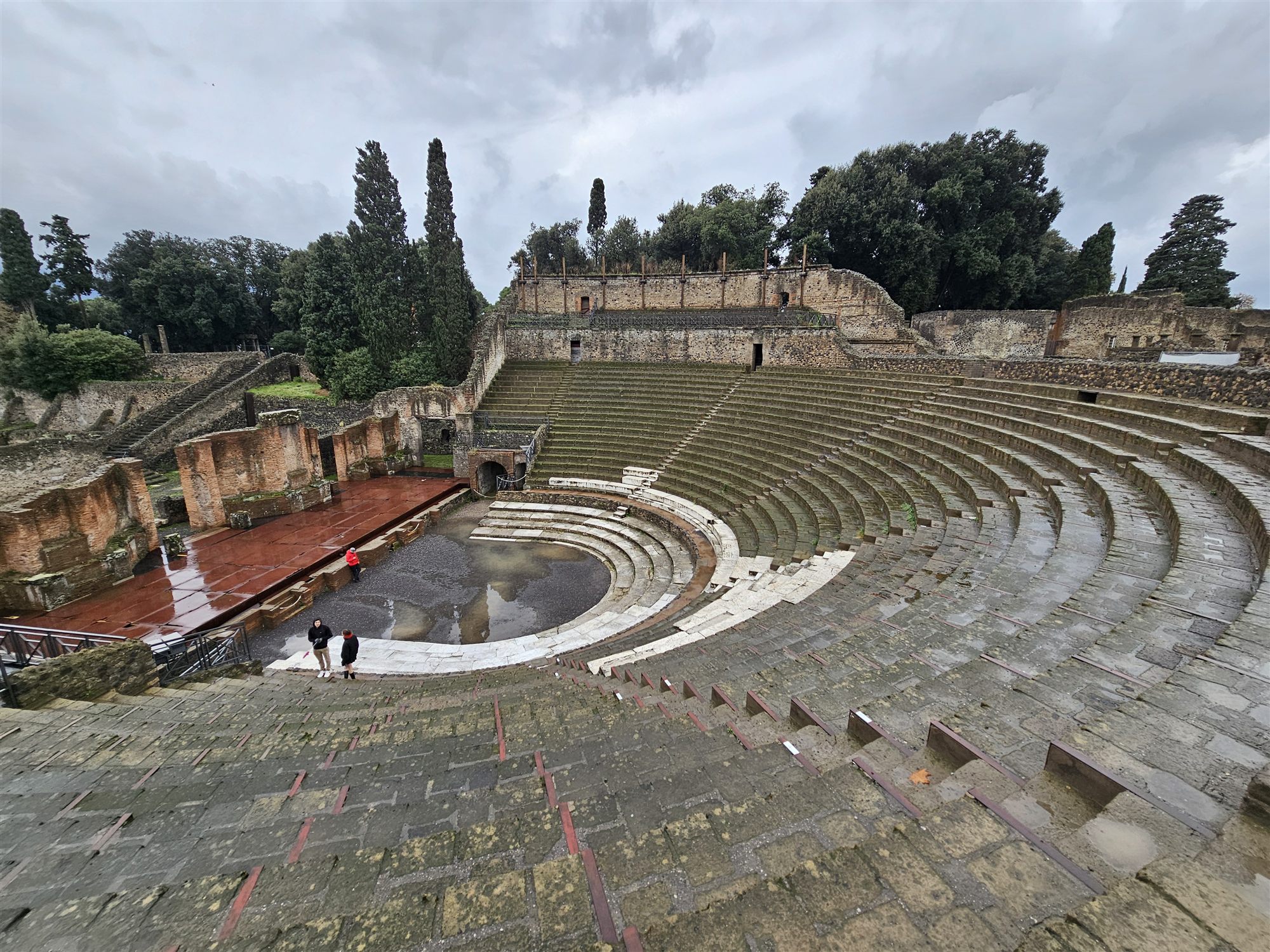 The Pompeii amphitheatre seen from its upper tiers, the oval arena and stone seating below