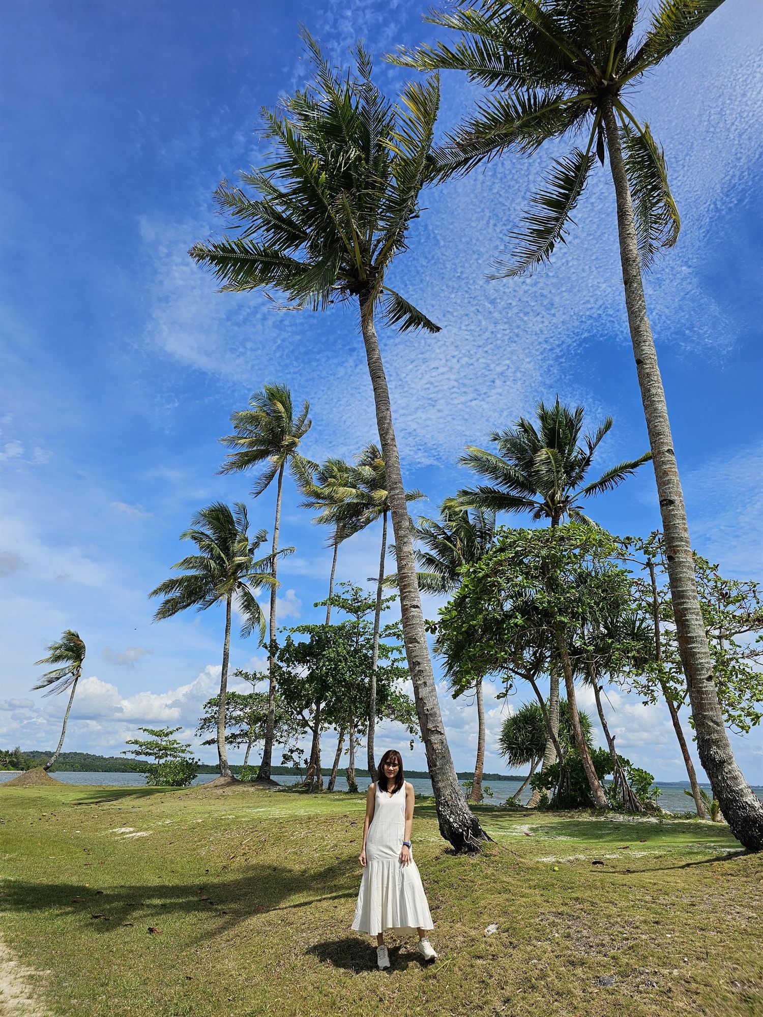 Walking among coconut palms at The Residence Bintan