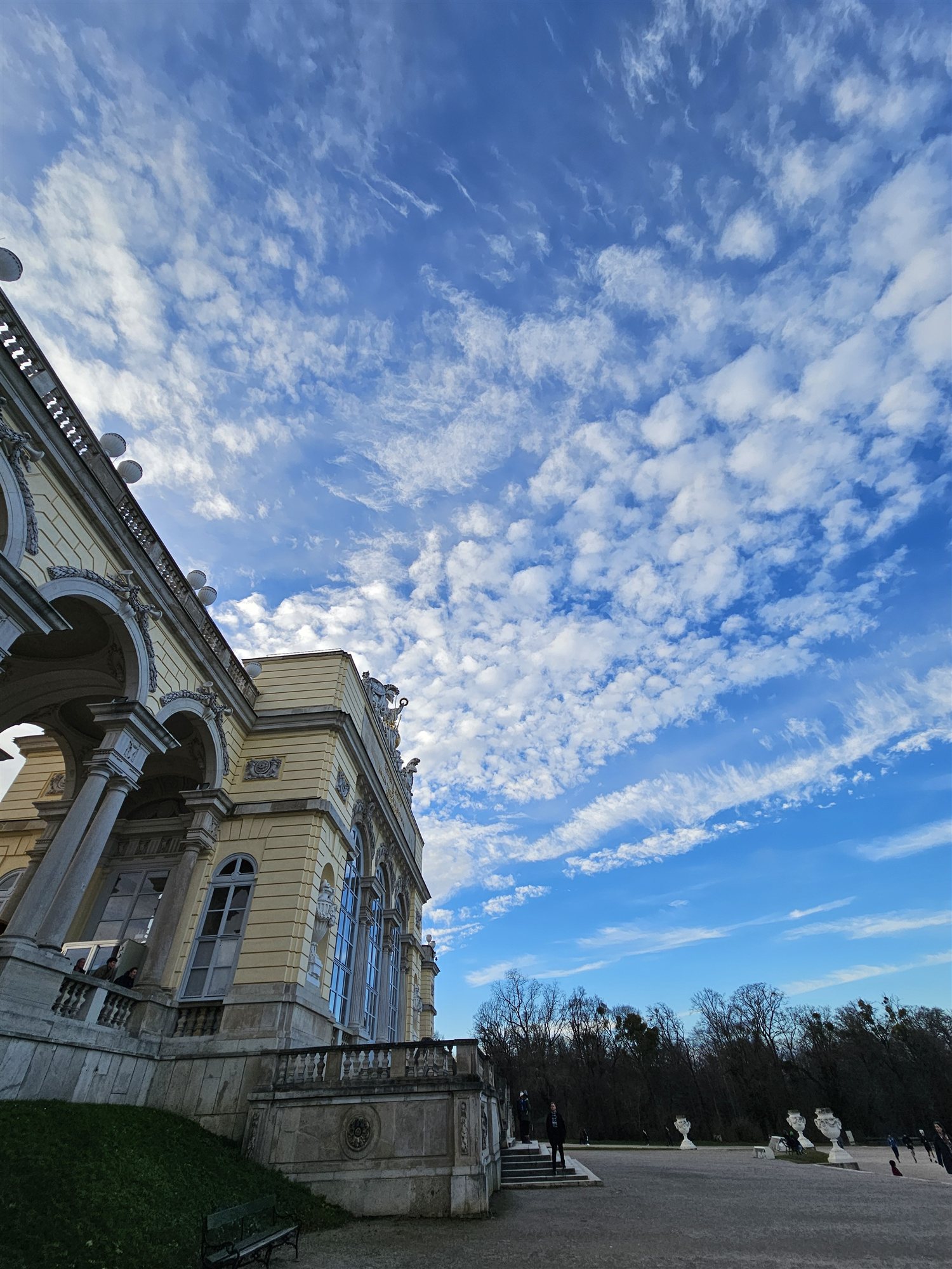 The colonnade of the Gloriette at Schönbrunn Palace, seen from below against a blue sky