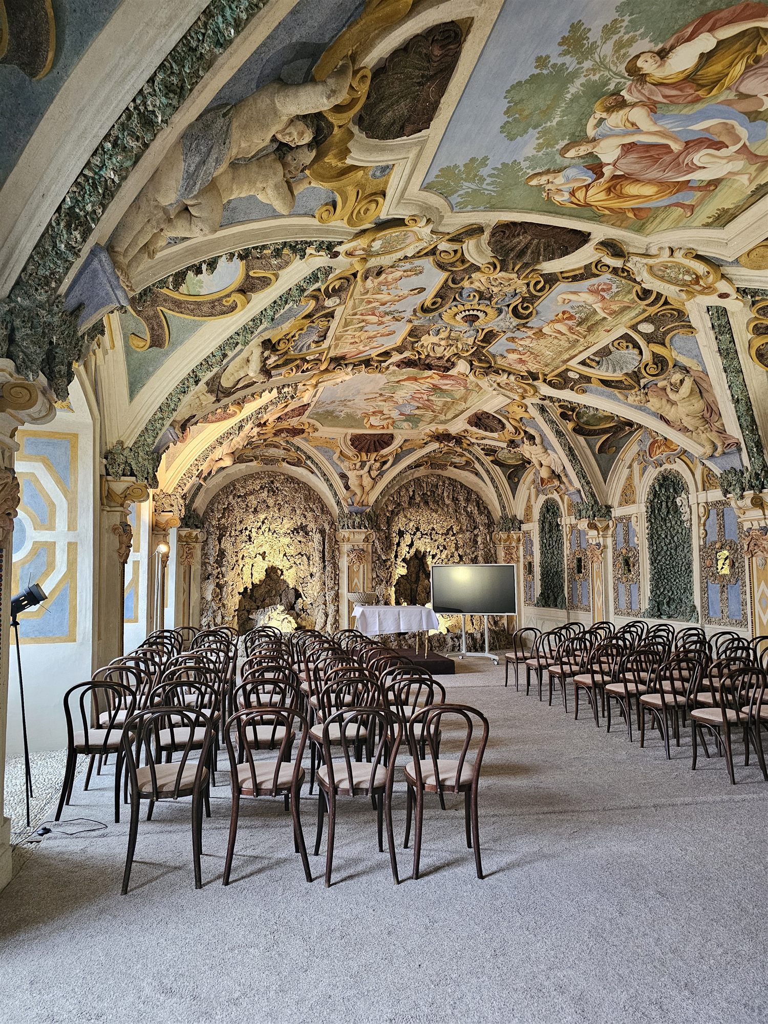 A Baroque grotto-style hall inside Smolenice Castle, with rocaille walls and a painted ceiling