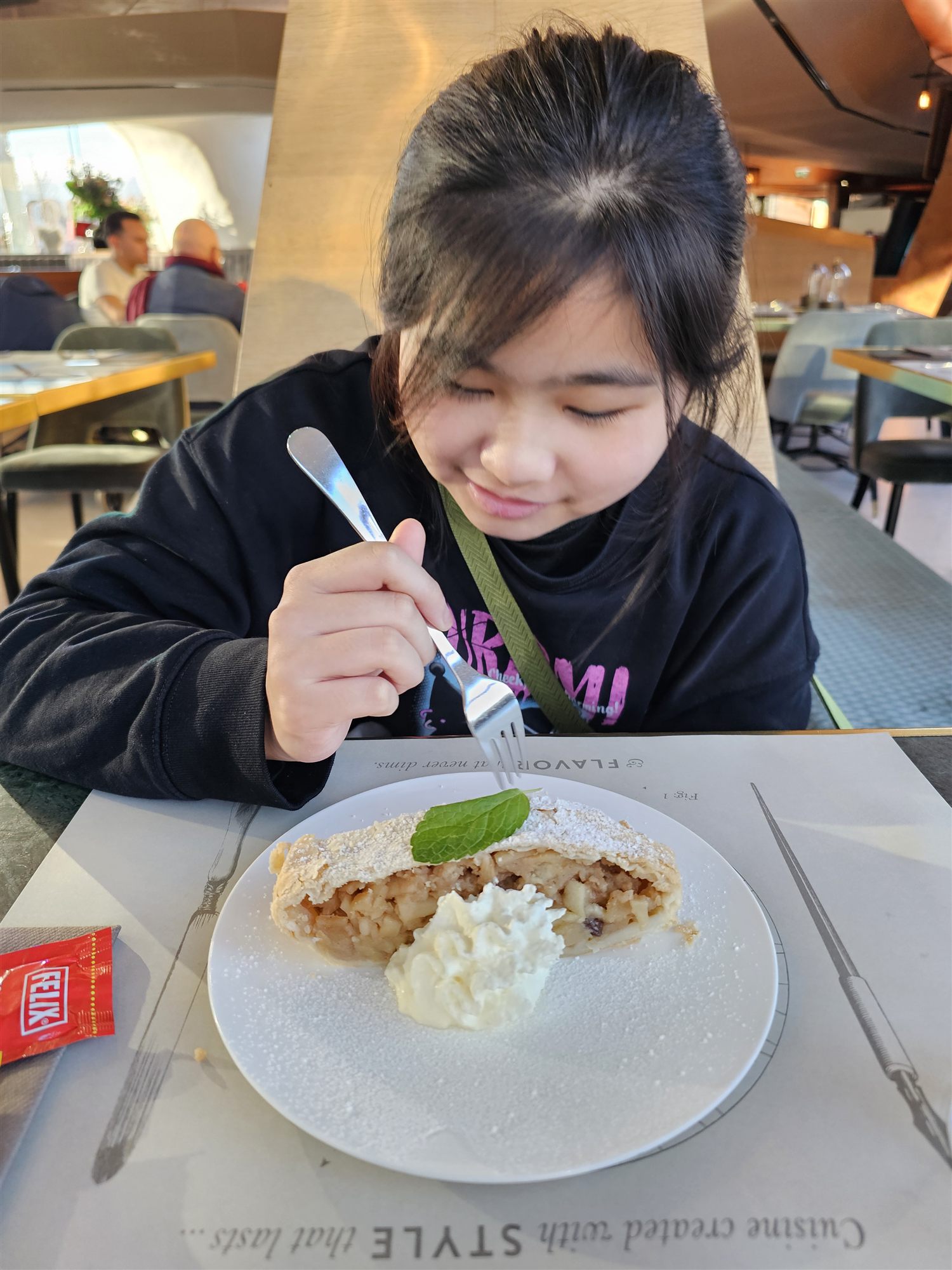 Our daughter eating apple strudel with cream at Daniels Kristallwelten