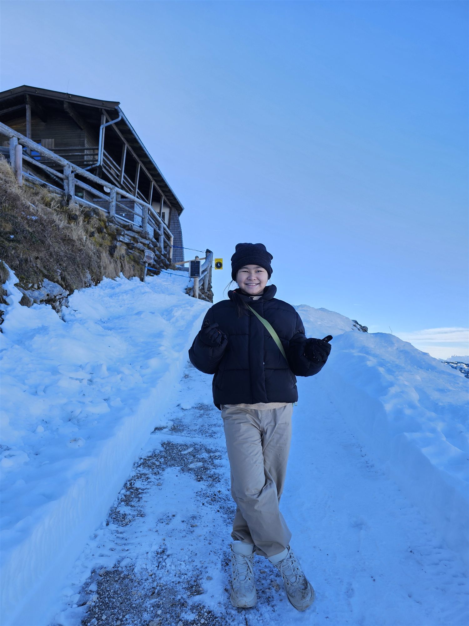 Our daughter in the snow near a mountain hut at Untersberg's summit station