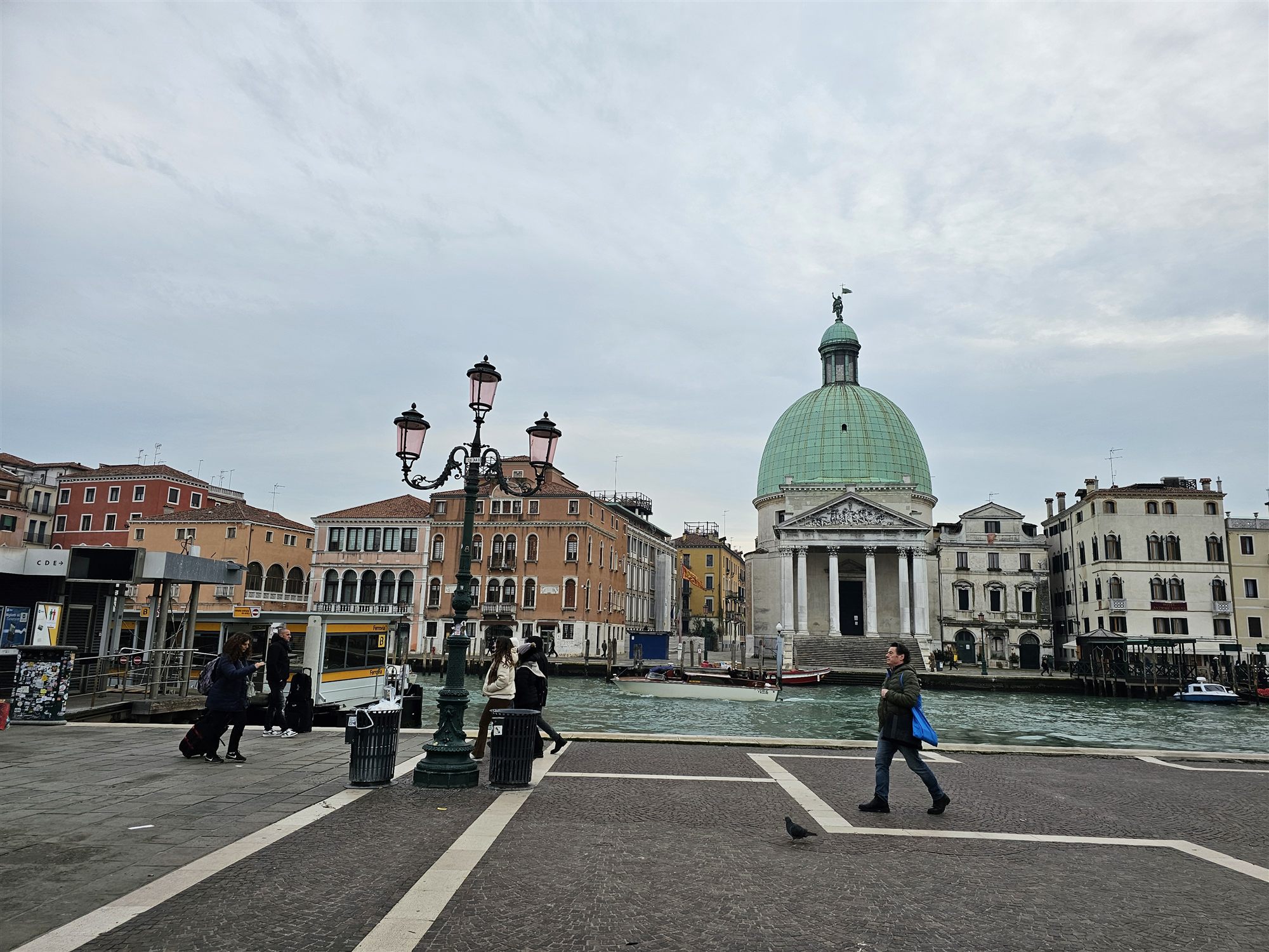The green copper dome of San Simeon Piccolo across the Grand Canal, a vaporetto stop and lamppost in the foreground