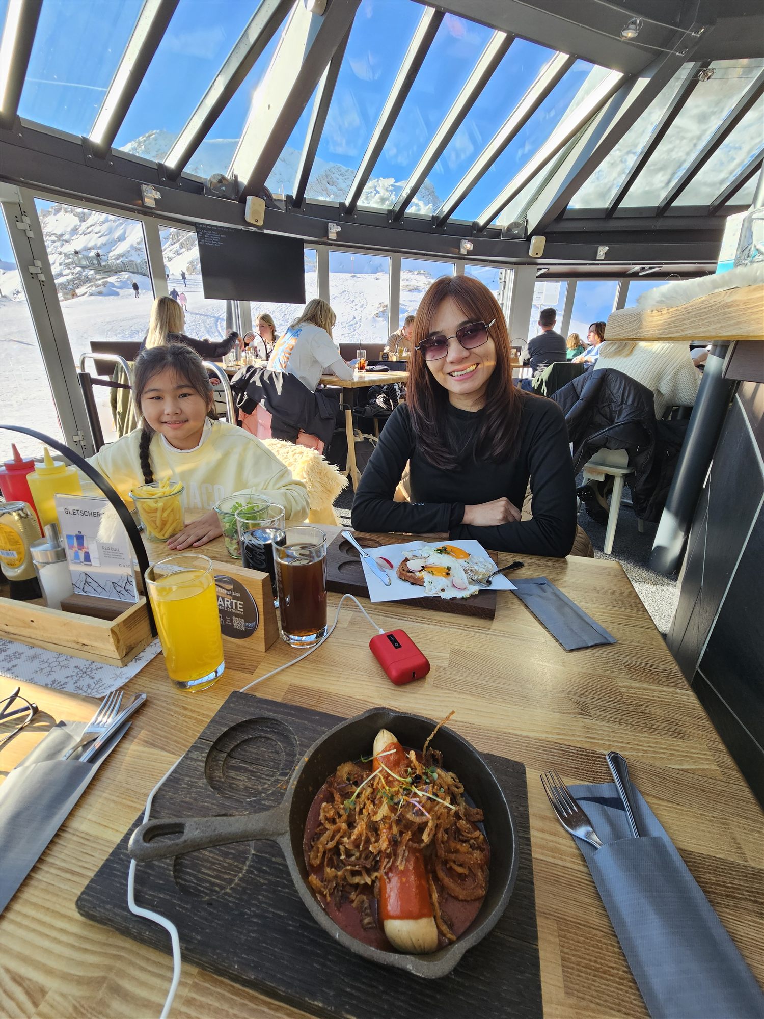 Lunch at Sonn Alpin on Zugspitze, sausage in a cast-iron pan and fried eggs under the glass roof