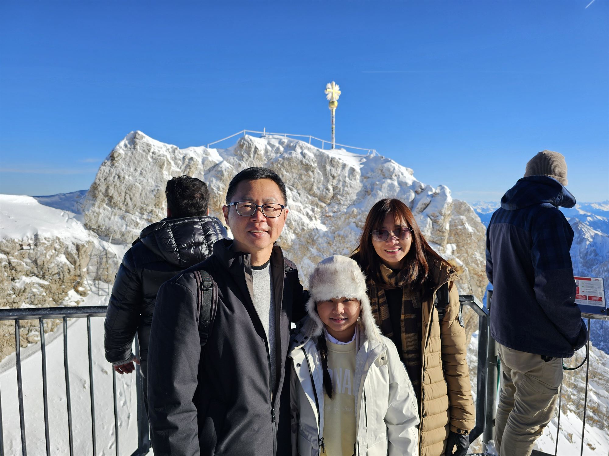The family at the summit cross marking Zugspitze's highest point